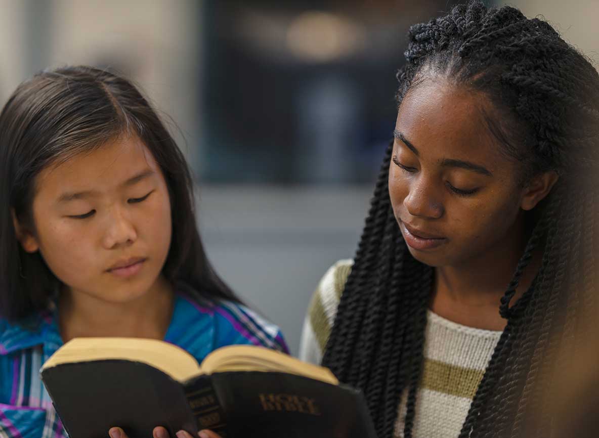 Two Children Reading Bible